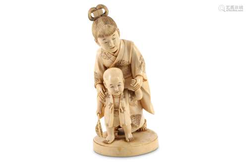 AN IVORY OKIMONO OF A YOUNG GIRL AND A BOY.