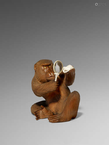 λ A JAPANESE BOXWOOD OKIMONO OF A MONKEY MEIJI 1868-1912 The primate depicted seated and examining a