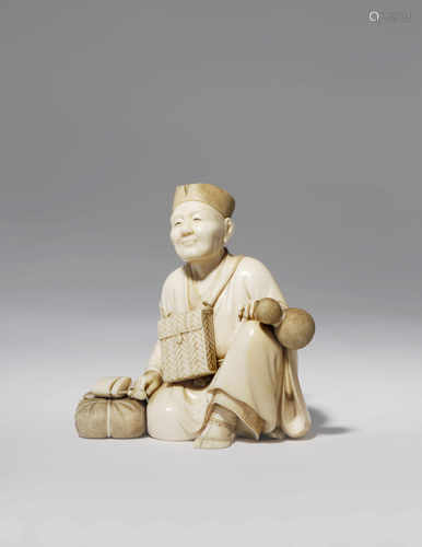 †λ A GOOD JAPANESE IVORY CARVING, OKIMONO MEIJI 1868-1912 Depicting a travelling monk, the elderly