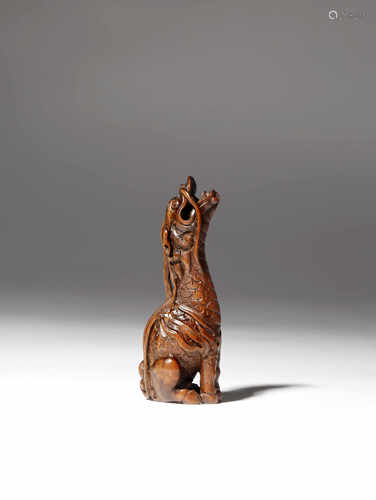 A JAPANESE WOOD NETSUKE OF A KIRIN MEIJI 1868-1912 After a design by Tomotada of Kyoto, the mythical