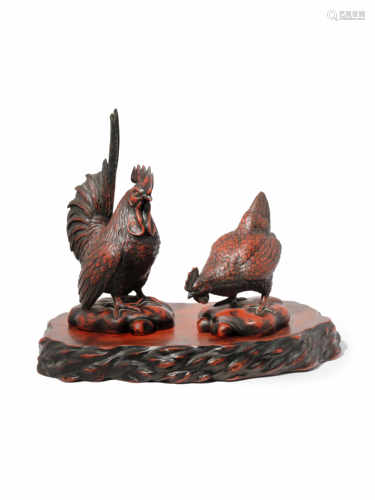 A PAIR OF JAPANESE RED LACQUER MODELS OF CHICKENS 20TH CENTURY One bird standing upright and the