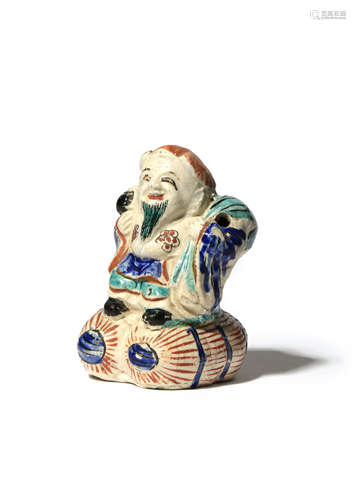 A KAKIEMON FIGURE OF DAIKOKU C.1700 The God of Good Fortune depicted standing on two large rice