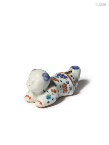 A JAPANESE KAKIEMON-STYLE WHISTLE C.1700 Modelled as a small boy lying on his belly, smiling and