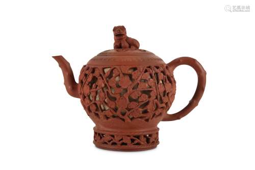 A CHINESE YIXING ZISHA RETICULATED TEAPOT AND COVER.
