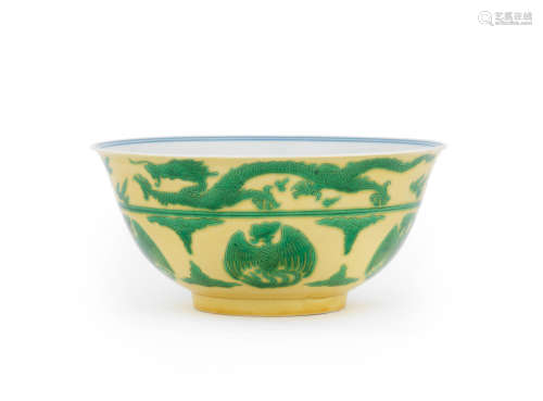 Kangxi six-character mark and of the period A rare yellow-ground green-enamelled 'dragon and phoenix' bowl