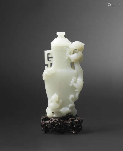 Qianlong A rare pale green jade 'dragon and young' vase and cover