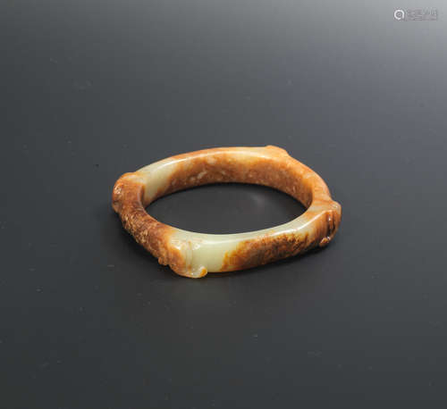 Song/Ming Dynasty A yellow and russet jade 'four elephants' bangle