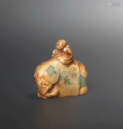 Ming Dynasty A green and russet jade 'elephant and boy' group
