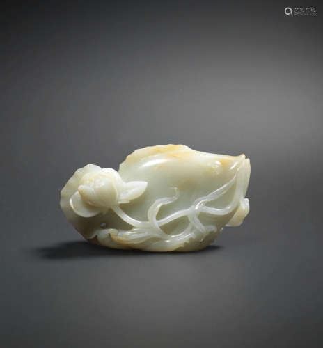 17th/18th century  A pale green and russet jade carving of a fish and lotus pond