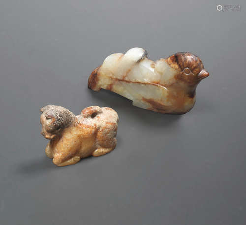 A white and russet jade bird and a brown jade horse