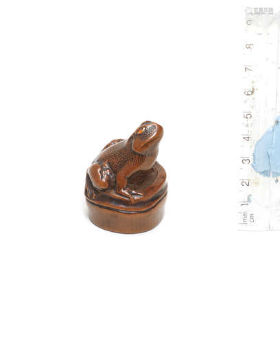 Attributed to Mitani Goho, Aki Province, late 18th/early 19th century A boxwood netsuke of a frog on bamboo