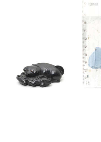 By Kanman (1793-1859), Iwami Province, early 19th century A rare ebony netsuke of a puppy and frog