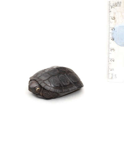 By Kanman (1793-1859), Iwami Province, early 19th century A kurogaki (black persimmon) wood netsuke of a tortoise
