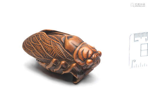 By Rimu, probably Iwami Province, early 19th century A boxwood netsuke of a cicada on a leaf