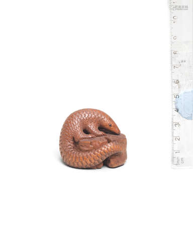 By Michael Webb (1934-2011), Yorkshire, England, dated 1983 A boxwood netsuke of a pangolin