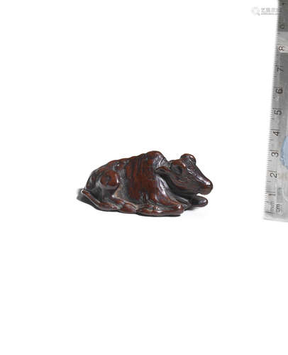 Attributed to Tsunesato, late 18th/early 19th century A wood netsuke of a recumbent ox