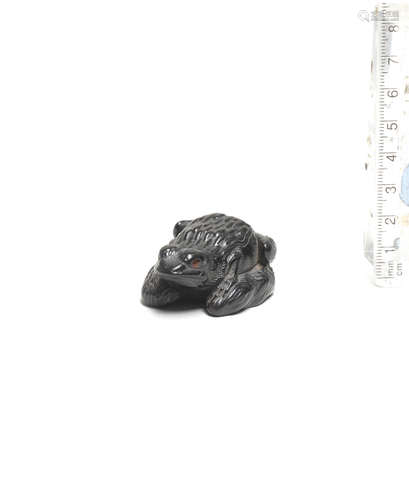 By Seiyodo Gansui (1809-1848), early 19th century An ebony netsuke of a frog on driftwood