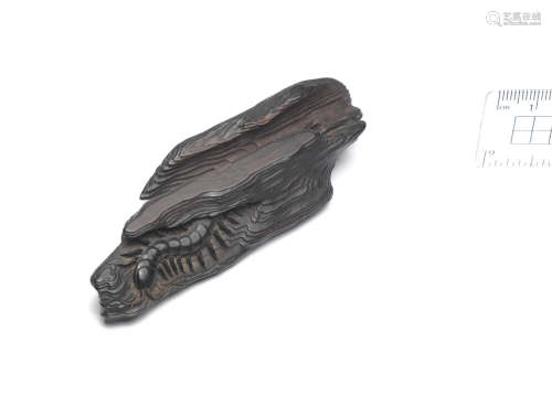 Attributed to Seiyodo Tomiharu (1733-1810), late 18th/early 19th century A large kurogaki (black persimmon) wood netsuke of a centipede on driftwood