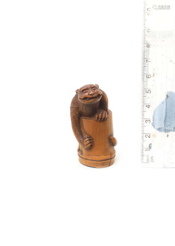 By Baiseki, Iwami Province, late 18th/early 19th century A boxwood netsuke of a tiger in bamboo