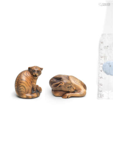 By Jack Coutu (1924-2017), English, the first carved September 1988, the second carved April 1997 Two boxwood netsuke of a wildcat and a fawn