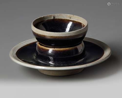 A Chinese black glazed cup and cup stand