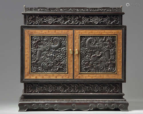 A small Chinese carved zitan cabinet