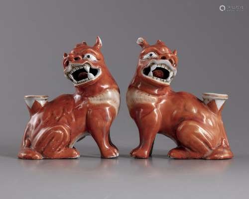 A pair of iron red glazed fu lions