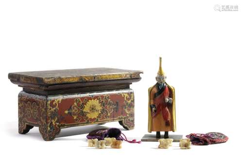 A Mongolian lacquered wood offering table, a polychrome-decorated wood figure of a Lama, and two embroidered bags