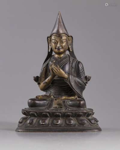 A gilt bronze figure of Lama