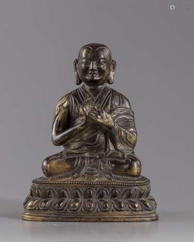 A gilt bronze figure of a Lama