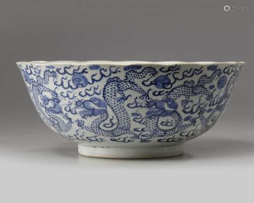 A Chinese blue and white foliate-rimmed 'nine dragon' bowl