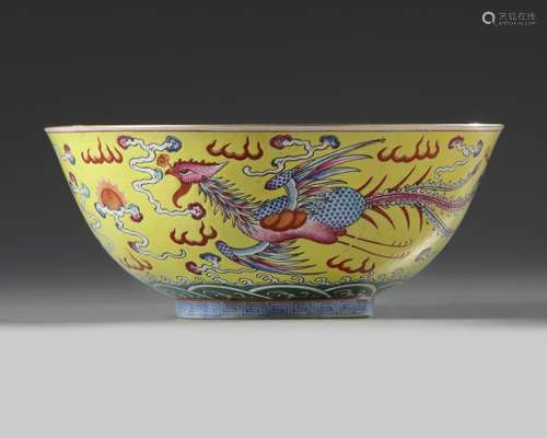 A Chinese yellow ground famille rose 'dragon and phoenix' bowl