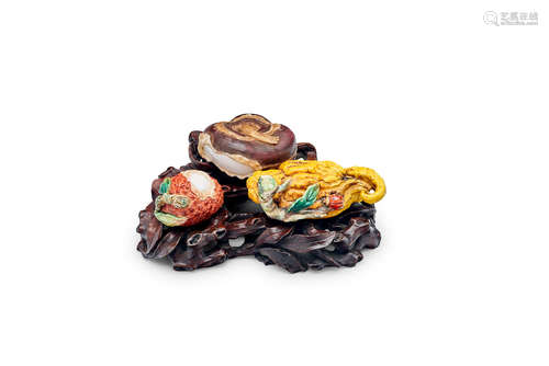 A group of three polychrome ceramic fruits