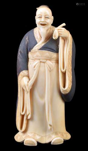 ϒ A Japanese Ivory Okimono of a Nobleman standing in voluminous robes and holding up a spoon