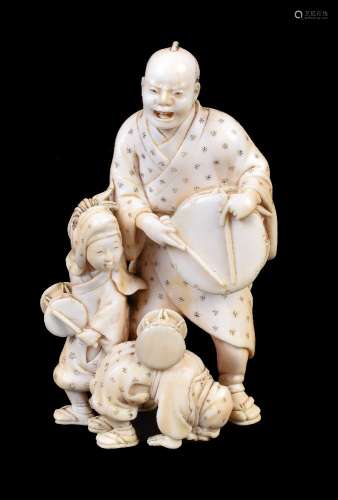 ϒ IKKOSAI: A Japanese Ivory Okimono of a man and his two children as street performers