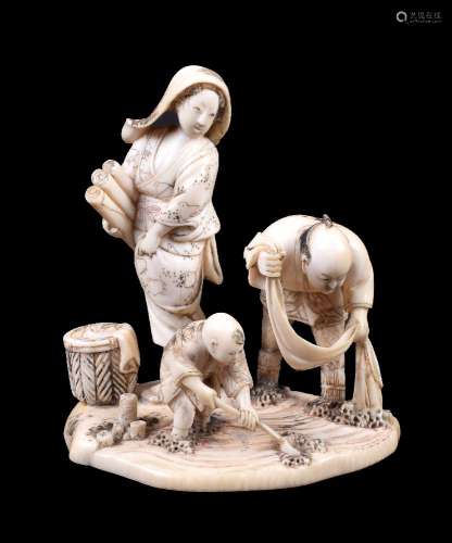 ϒ KIKKOSAI TOKUSAN: A Japanese Ivory Okimono depicting a family group