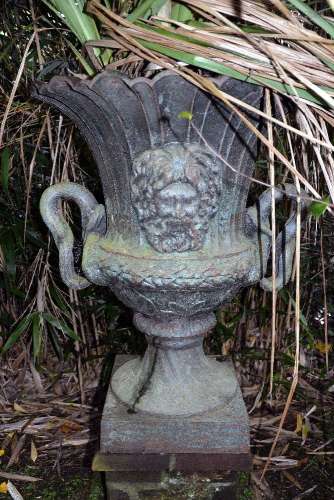 A cast iron twin handled garden urn