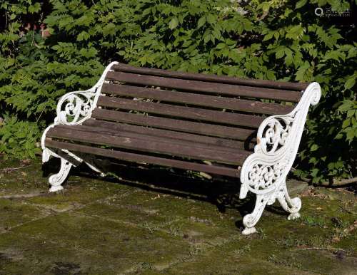 A white painted cast iron and slatted wood garden bench