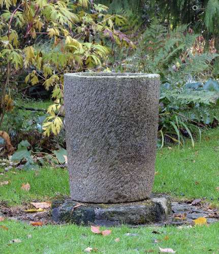 A rough hewn stone planter
