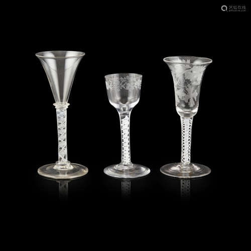GROUP OF THREE GEORGIAN OPAQUE TWIST STEMMED WINE GLASSES 18TH CENTURY comprising an ogee-pointed
