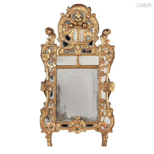 ITALIAN CARVED GILTWOOD MIRROR 18TH CENTURY the divided mirror plate within a scrolling giltwood