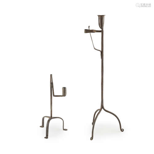 TWO IRON RUSHLIGHT HOLDERS 18TH CENTURY both raised on tripod bases, the larger, 53cm high; and