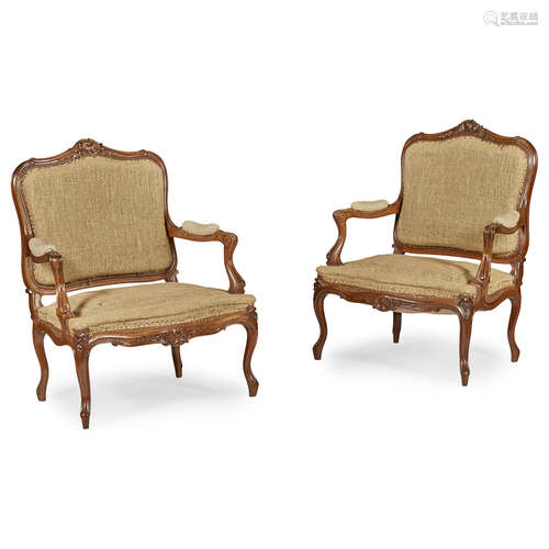 PAIR OF FRENCH CARVED WALNUT ARMCHAIRS 19TH CENTURY the wide cartouche-shaped backs with floral