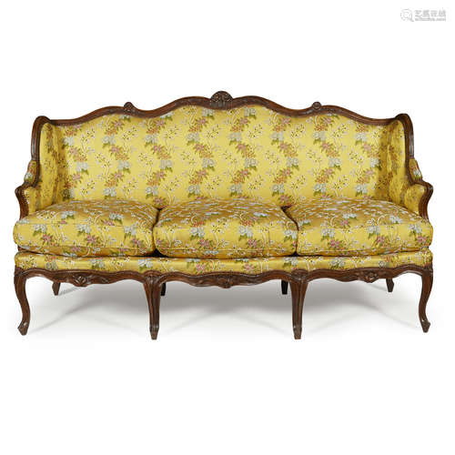 LOUIS XV WALNUT FRAMED SOFA MID 18TH CENTURY the floral carved and scrolled toprail above a padded