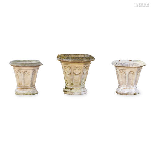 THREE HADDONSTONE 'GOTHIC VASE' JARDINIERES comprising a pair with lancet panels, 49cm wide, 52cm