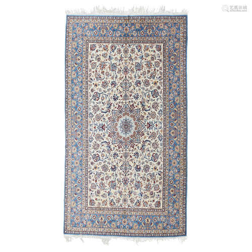 ISFAHAN CARPET CENTRAL PERSIA, 20TH CENTURY the cream field with cusped medallion, within blue