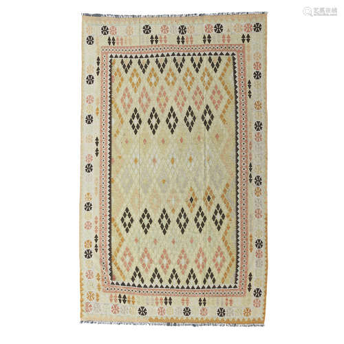 KILIM CARPET PERSIA, 20TH CENTURY the olive field with allover polychrome lozenge pattern, within