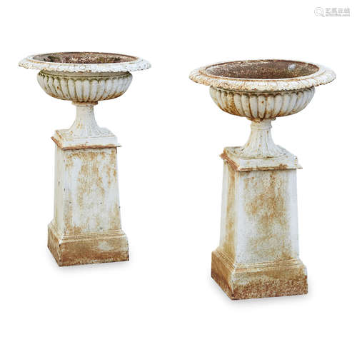 PAIR OF VICTORIAN SMALL CAST IRON URNS AND STANDS LATE 19TH CENTURY of low campana form with egg and