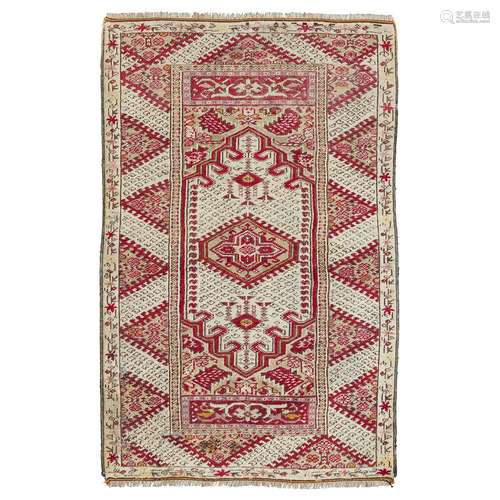 GHIORDES RUG WEST ANATOLIA, 19TH CENTURY the cream field with green lozenge medallion, green