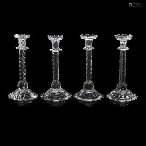SET OF FOUR GEORGIAN CUT-GLASS CANDLESTICKS LATE 18TH CENTURY with lobed nozzles raised on faceted